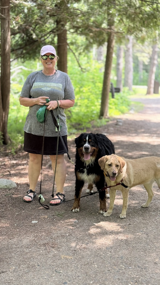 Maureen with Charlie, our Bernese Mountain Dog, and Maggie, our yellow Labrador