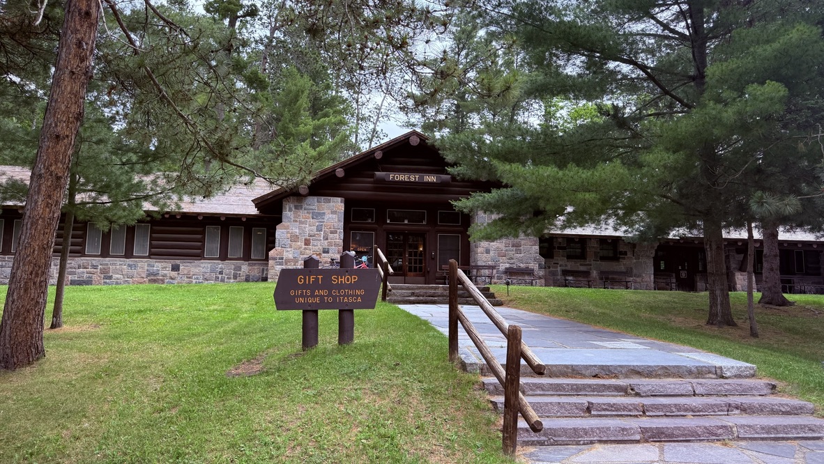 A rustic lodge framed by tall pines